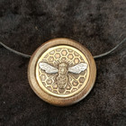 close-up of The Bee pendant
